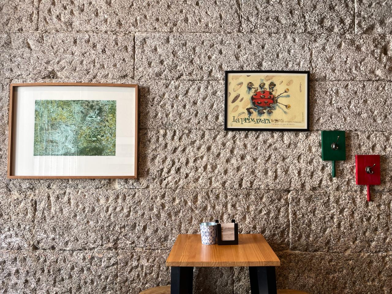 Pared de piedra con cuadros y banco corrido